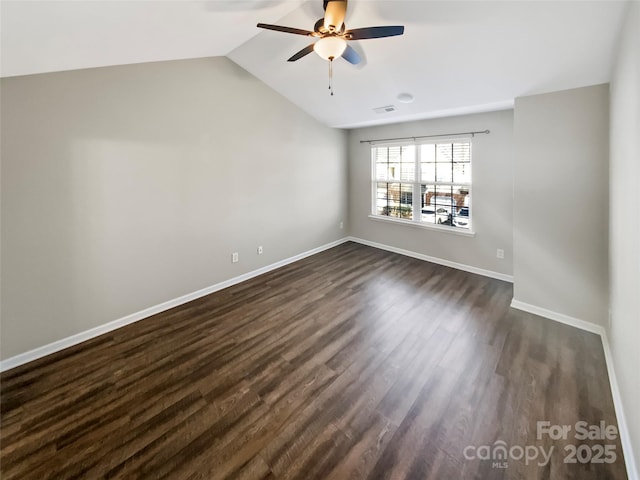 unfurnished room with lofted ceiling, ceiling fan, visible vents, baseboards, and dark wood finished floors