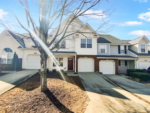 view of front of house with a garage, driveway, and brick siding