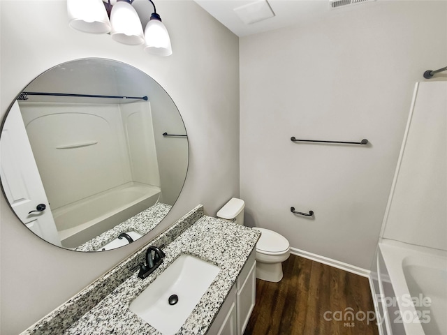 full bathroom featuring vanity, shower / tub combination, wood finished floors, and toilet