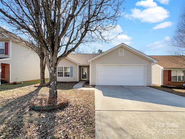 ranch-style house with concrete driveway and an attached garage