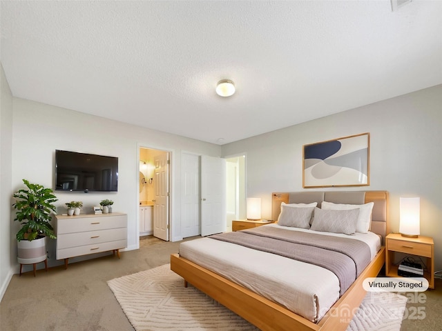 bedroom featuring connected bathroom, baseboards, a textured ceiling, and light colored carpet