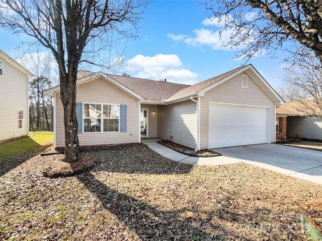 ranch-style home featuring concrete driveway, a shingled roof, and an attached garage