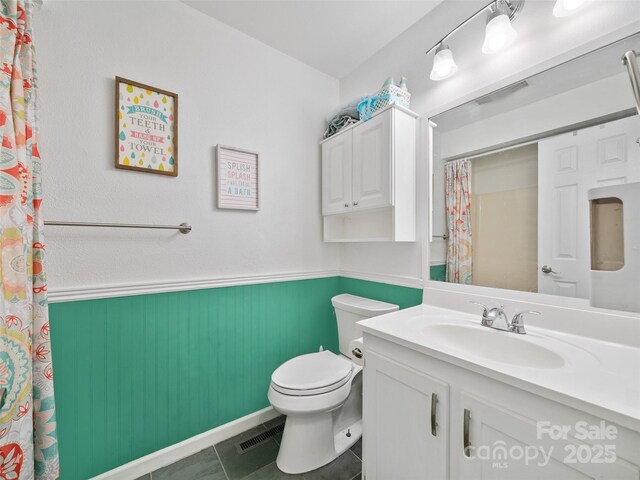 48 Meadowlark Ln, Spruce Pine, NC 28777 - bathroom featuring a wainscoted wall, toilet, tile patterned flooring, vanity, and a shower with shower curtain