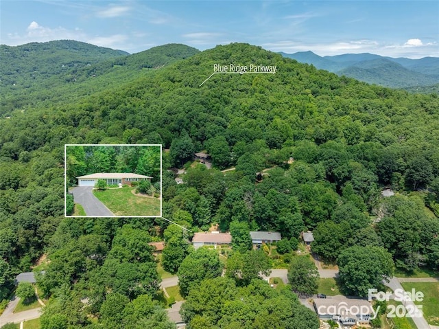 aerial view featuring a mountain view and a forest view