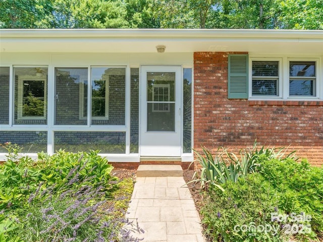 entrance to property with brick siding