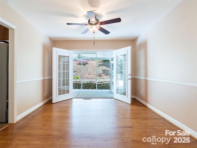 doorway to outside with french doors, ceiling fan, baseboards, and wood finished floors