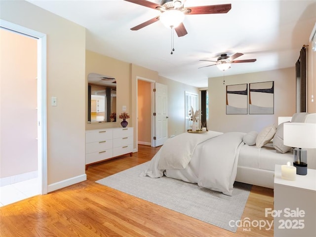 bedroom with a ceiling fan, light wood-type flooring, and baseboards