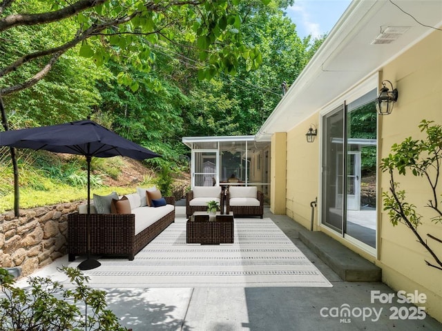 view of patio with outdoor lounge area and a sunroom