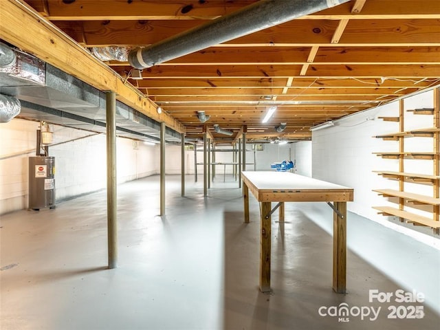 unfinished basement featuring water heater