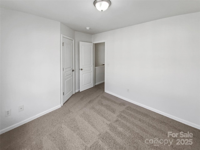 unfurnished bedroom with carpet and baseboards