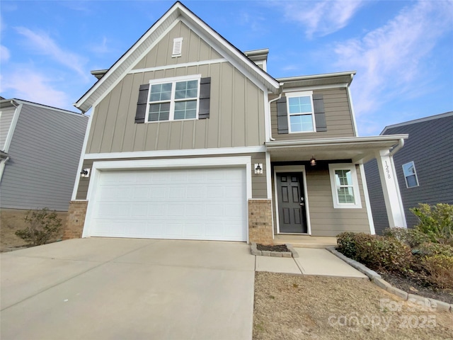 view of front of home with board and batten siding, concrete driveway, brick siding, and an attached garage