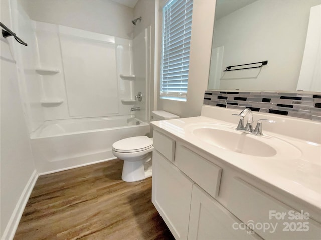 full bathroom featuring shower / bathing tub combination, decorative backsplash, toilet, vanity, and wood finished floors