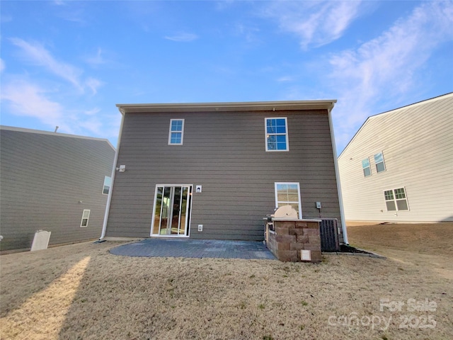 rear view of property featuring a yard, area for grilling, and a patio