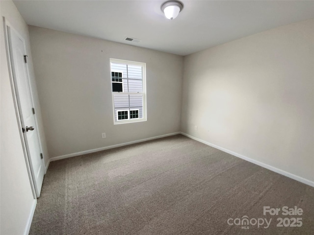 carpeted empty room with baseboards and visible vents