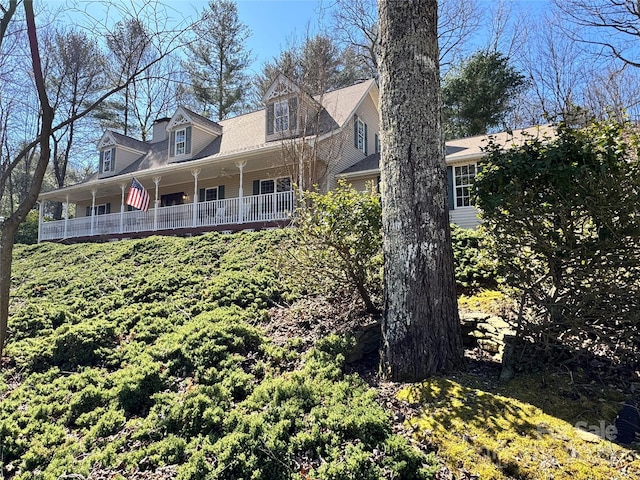 view of side of property featuring a porch