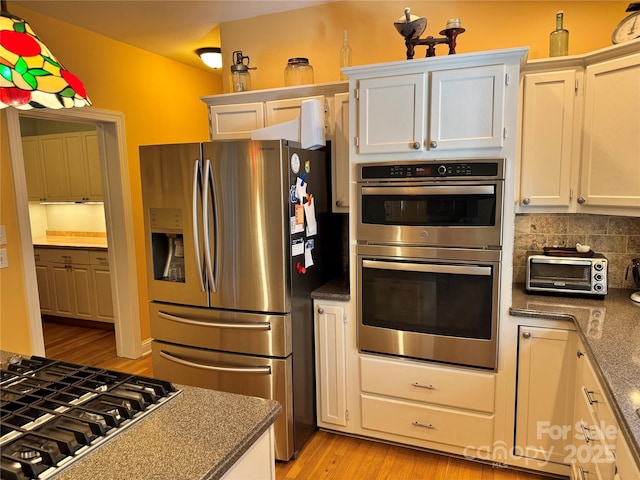 kitchen with appliances with stainless steel finishes and white cabinets