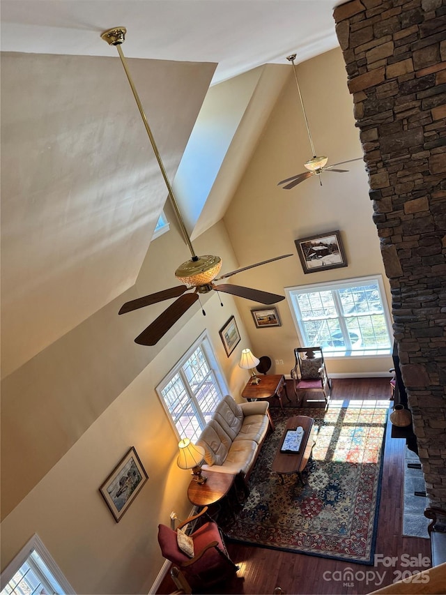 living room featuring high vaulted ceiling, a ceiling fan, and wood finished floors