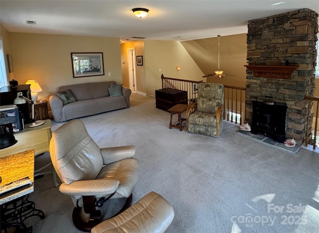 carpeted living area featuring visible vents, a fireplace, and ceiling fan