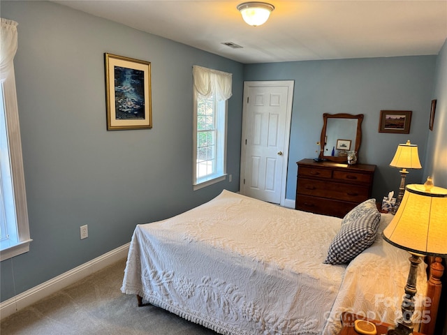 carpeted bedroom featuring visible vents and baseboards