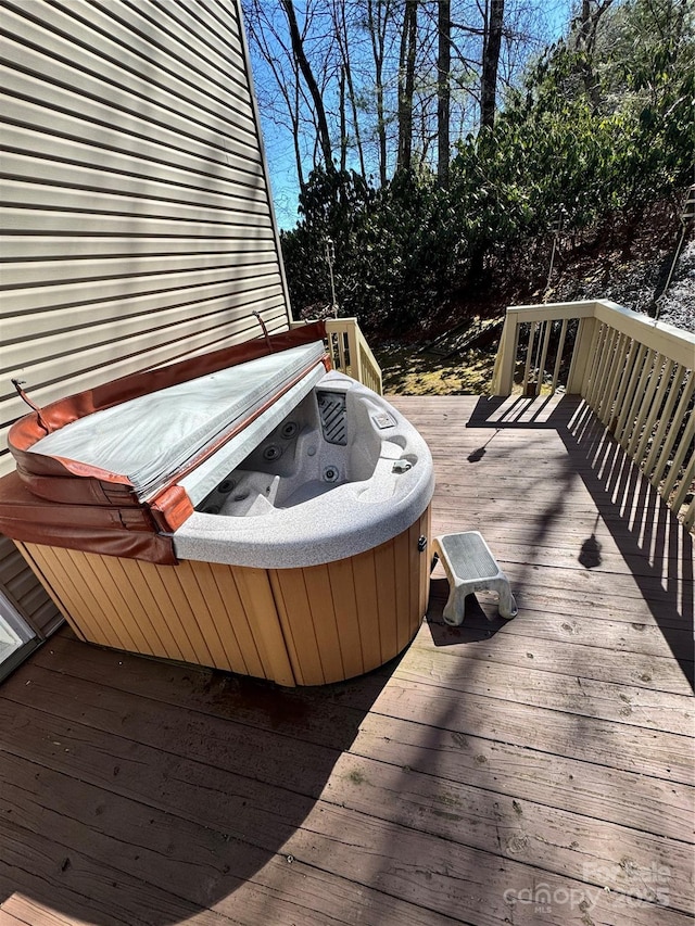 wooden terrace with a hot tub