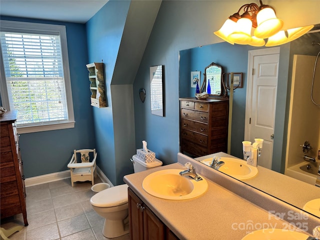 full bath featuring double vanity, tile patterned flooring, a sink, and toilet