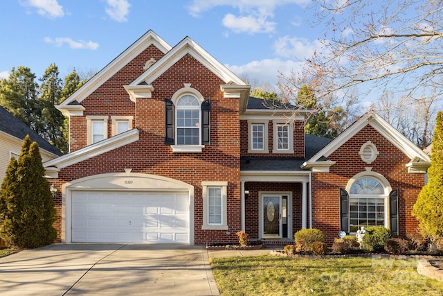 view of front of property with roof with shingles, a front lawn, concrete driveway, and brick siding