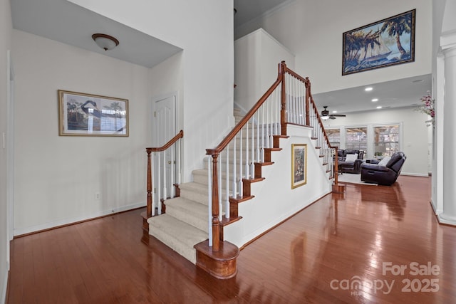 staircase featuring ceiling fan, recessed lighting, wood finished floors, and baseboards