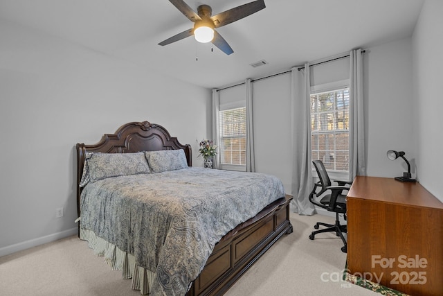 bedroom featuring light carpet, baseboards, visible vents, and a ceiling fan