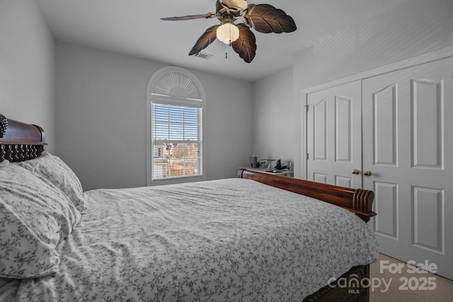 bedroom featuring ceiling fan and a closet