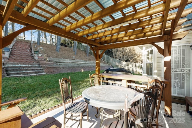 view of patio with outdoor dining area, fence, and a pergola