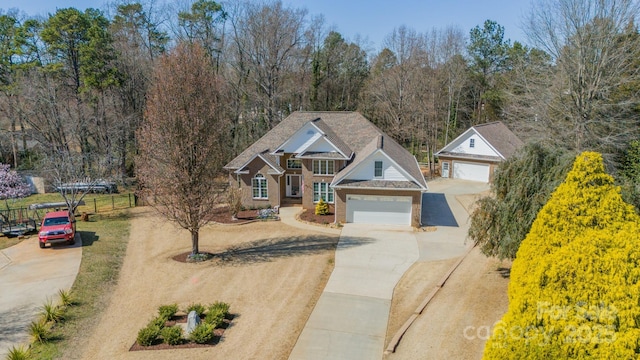 view of front of home with concrete driveway and fence