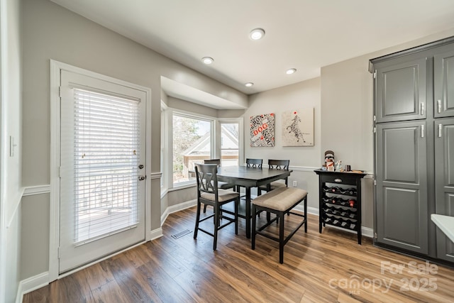 dining room with recessed lighting, baseboards, and wood finished floors