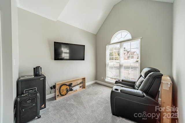 living area with baseboards, lofted ceiling, and carpet floors