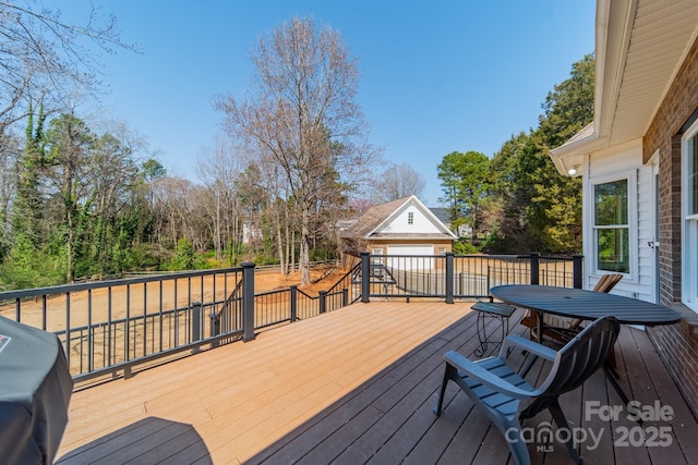 wooden terrace featuring an outbuilding