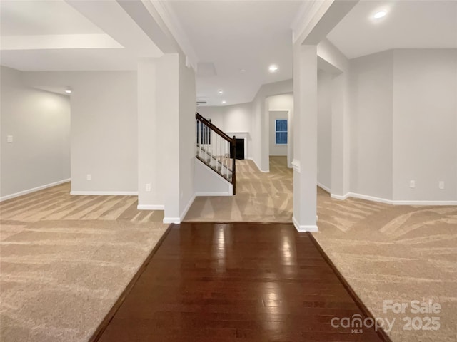 carpeted foyer with baseboards, stairway, wood finished floors, and recessed lighting