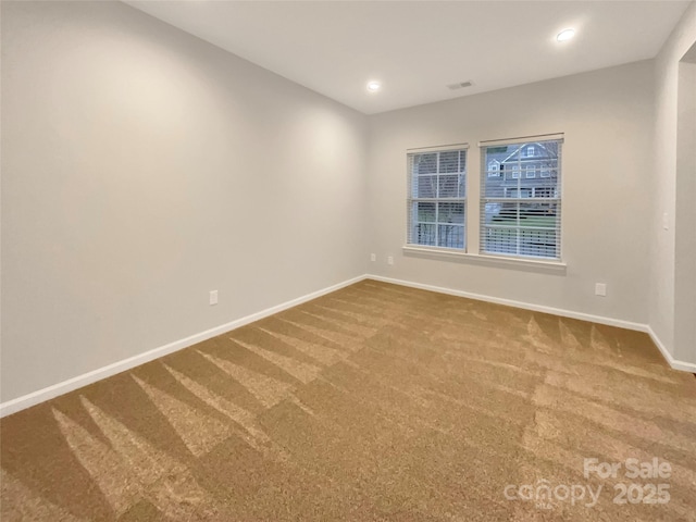 empty room featuring recessed lighting, carpet flooring, visible vents, and baseboards