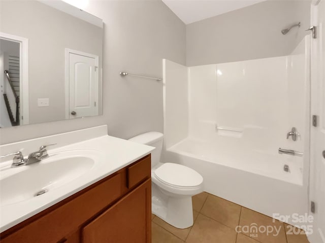 bathroom featuring toilet, vanity, shower / washtub combination, and tile patterned floors