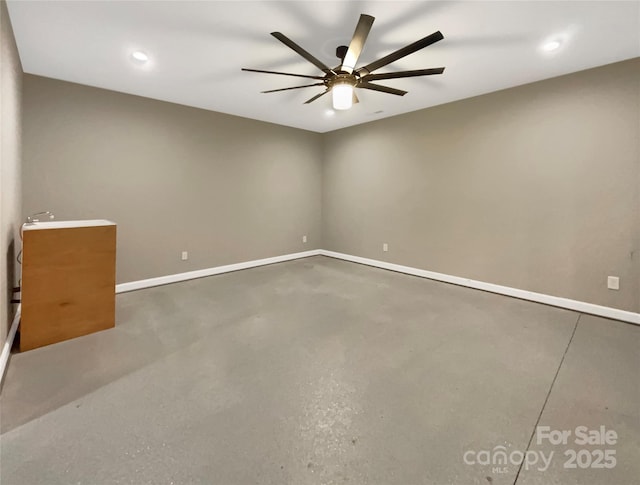 unfurnished room with ceiling fan, concrete floors, and baseboards