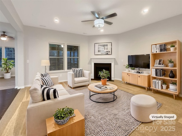 living room with recessed lighting, a fireplace, ceiling fan, and baseboards