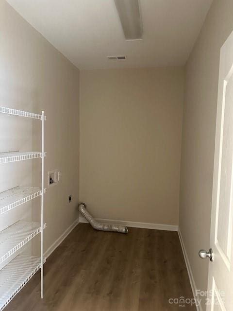 laundry area with hookup for a washing machine, laundry area, dark wood-style flooring, baseboards, and electric dryer hookup