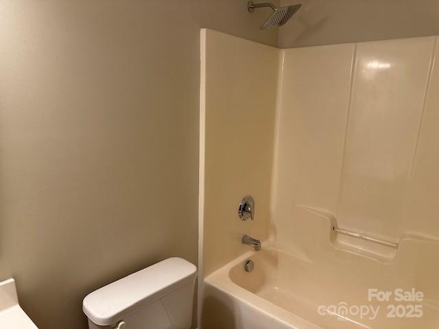 bathroom with shower / bath combination, visible vents, and toilet