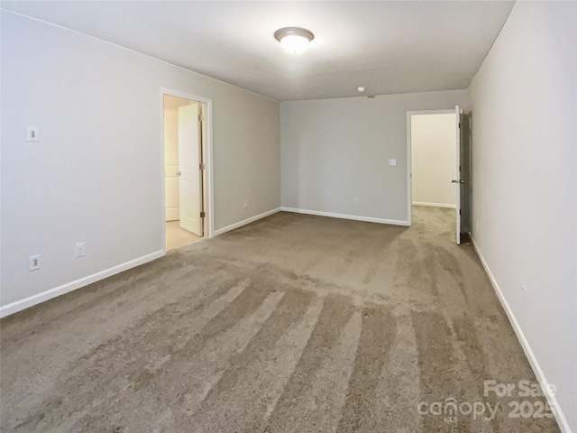 carpeted spare room with baseboards