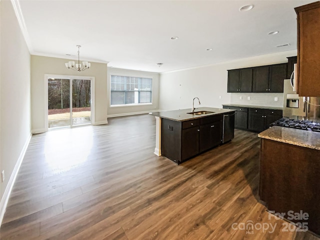 kitchen featuring ornamental molding, dark wood finished floors, open floor plan, and a sink