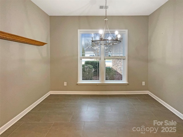 unfurnished dining area with a notable chandelier, visible vents, and baseboards