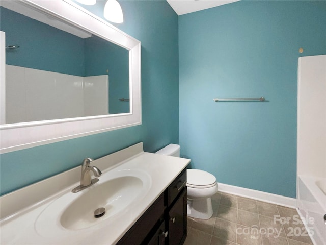 bathroom with tile patterned flooring, a bathing tub, toilet, vanity, and baseboards