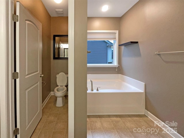 full bath with tile patterned floors, toilet, baseboards, and a bath