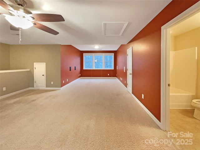 unfurnished room with light colored carpet, ceiling fan, and baseboards