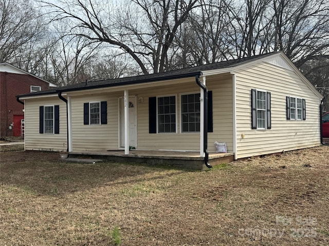 view of front of property with covered porch and a front yard