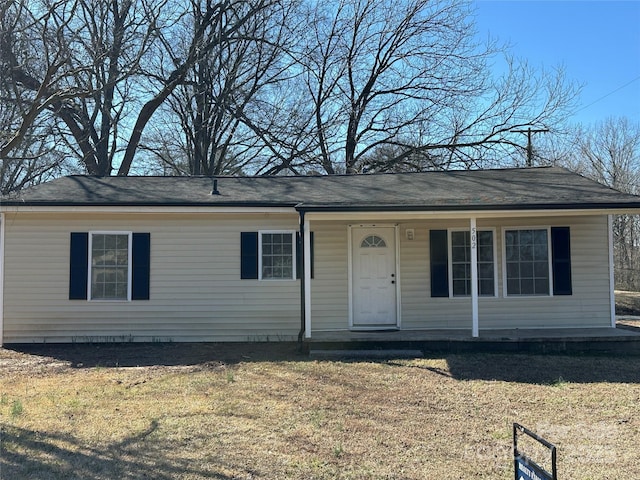 view of front of house featuring covered porch and a front yard