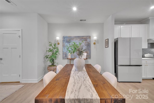 dining room featuring light wood-type flooring, visible vents, and recessed lighting